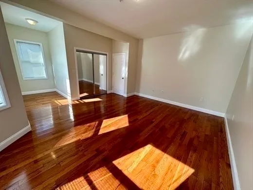 a view of a room with wooden floor and chair