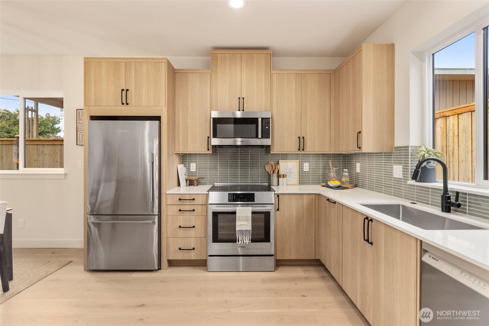 3404 33rd Avenue West Seattle, WA 98199 - Photo 14 of 29 a kitchen with stainless steel appliances granite countertop a refrigerator stove and sink