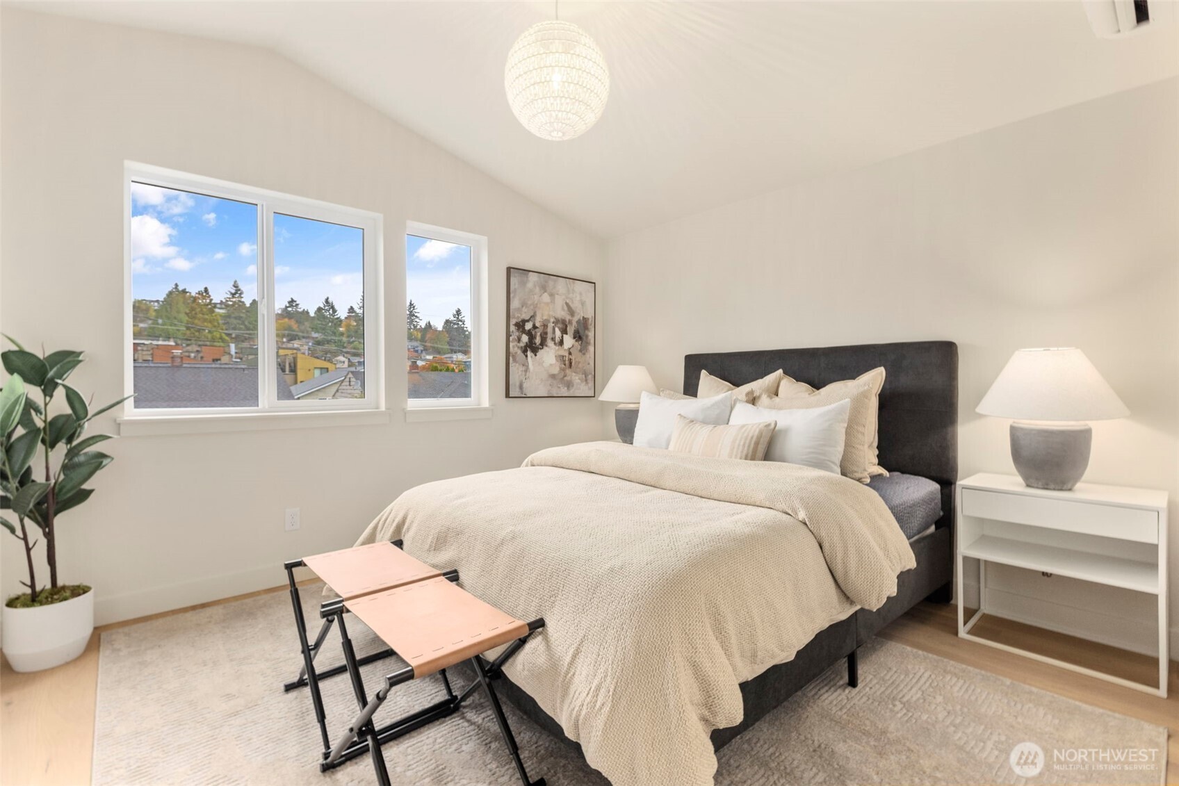 3404 33rd Avenue West Seattle, WA 98199 - Photo 18 of 29 a bedroom with a bed and a potted plant