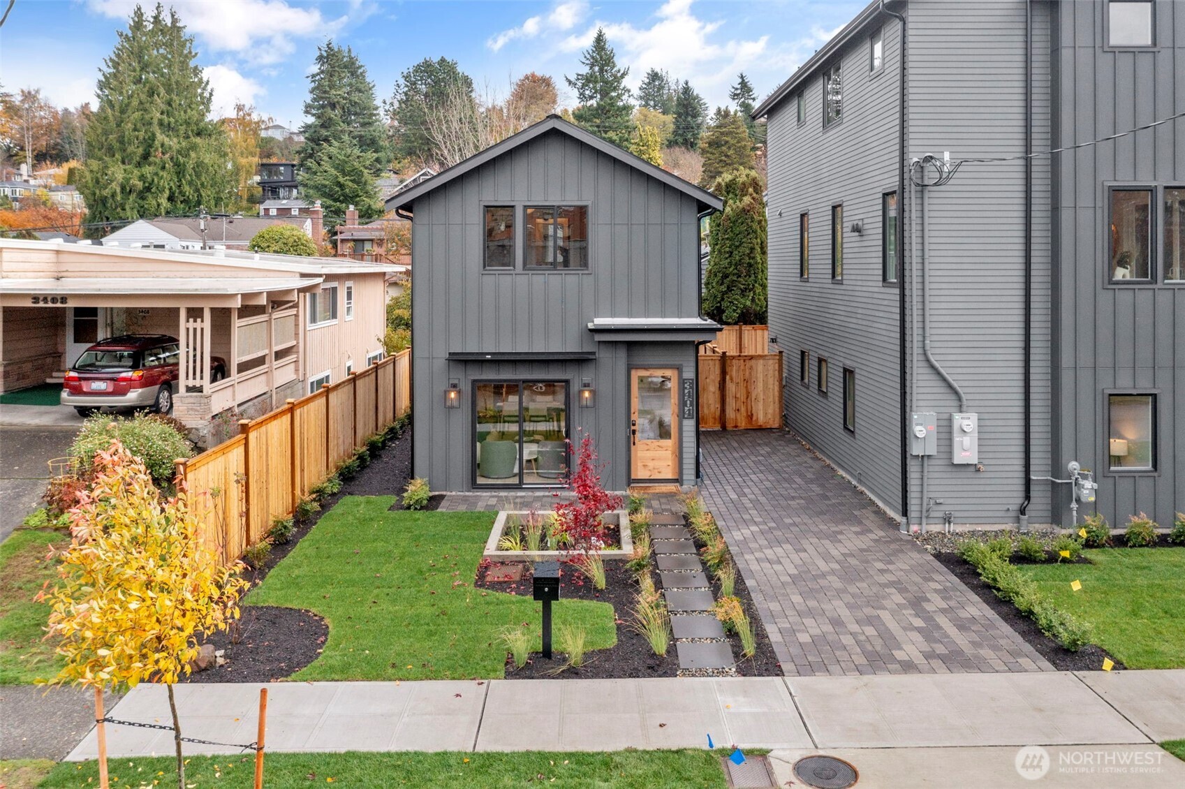 3404 33rd Avenue West Seattle, WA 98199 - Photo 2 of 29 a front view of a house with a yard table and chairs