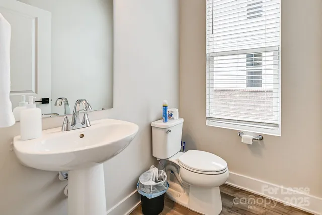 a bathroom with a sink a toilet and a mirror