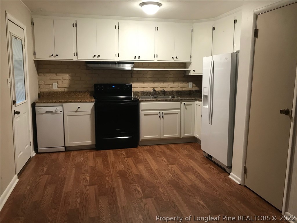 1602 Crescent Drive Spring Lake, NC 28390 - Photo 5 of 12 a kitchen with a sink and a refrigerator