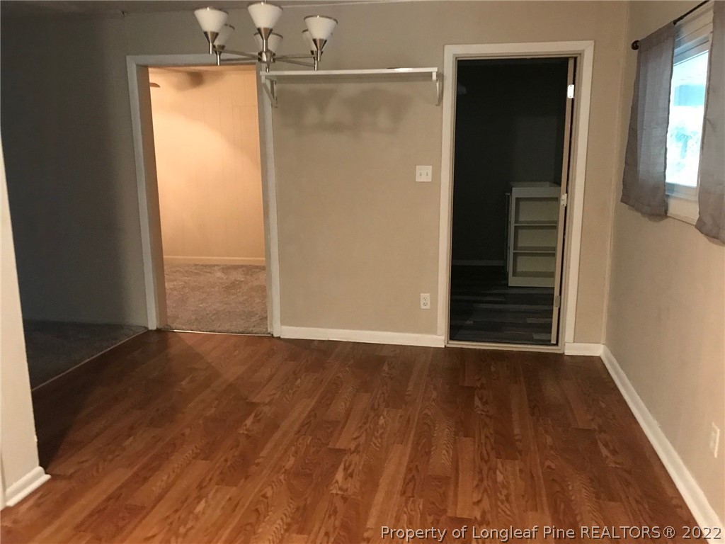 1602 Crescent Drive Spring Lake, NC 28390 - Photo 6 of 12 an empty room with wooden floor and windows