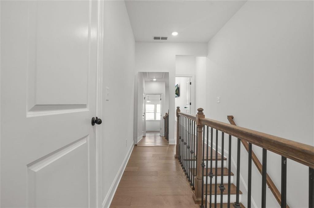 3927 Allegretto Circle Atlanta, GA 30339 - Photo 15 of 54 a view of a hallway with wooden floor and a bathroom