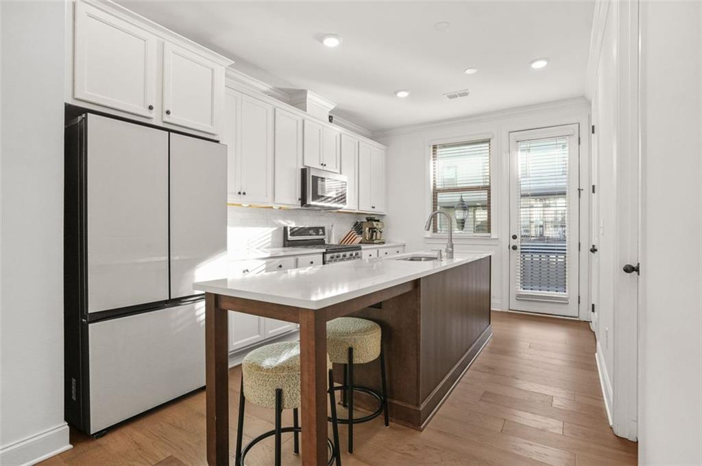 3927 Allegretto Circle Atlanta, GA 30339 - Photo 10 of 54 a kitchen with kitchen island cabinets and refrigerator