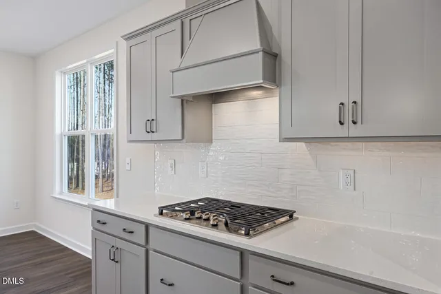 a kitchen with white cabinets and appliances