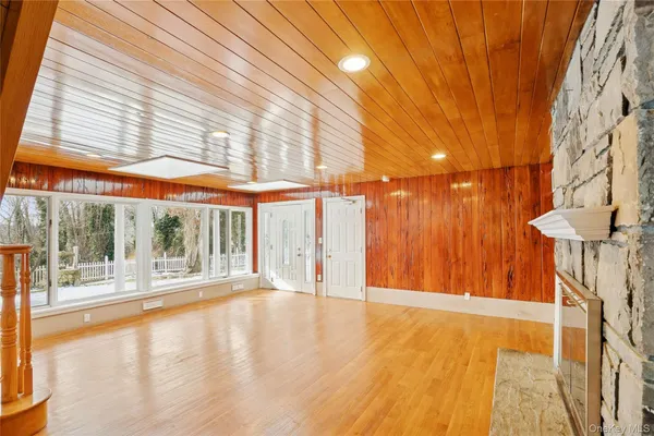 a view of a room with wooden floor and iron stairs