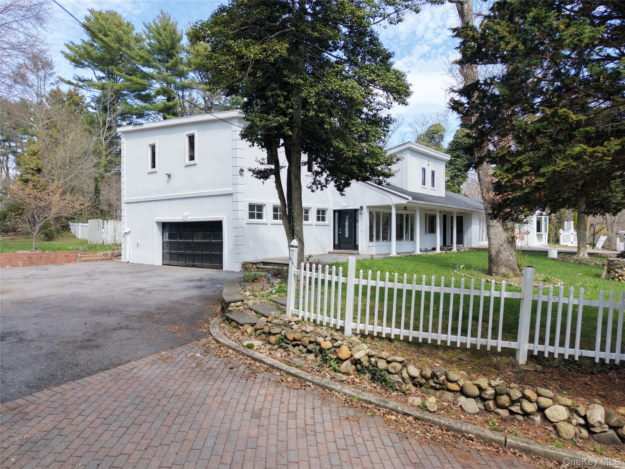 549 Woodbury Road Cold Spring Harbor, NY 11724 - Photo 2 of 49 View of front of home with asphalt driveway, a garage, and covered porch