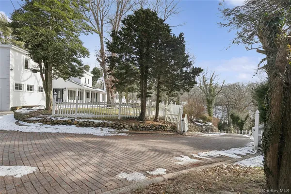 a view of a house with a yard covered in snow