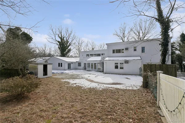 a view of a house with a yard covered with snow in the background