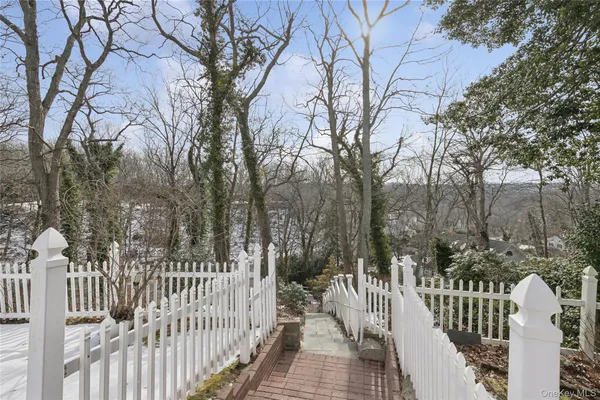 a view of a house with a wooden fence