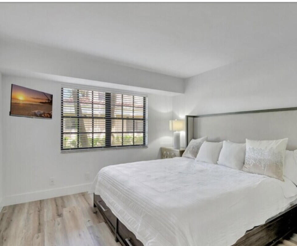 17372 Boca Club Boulevard, Unit 408 Boca Raton, FL 33487 - Photo 12 of 18 a bedroom with a bed and a window