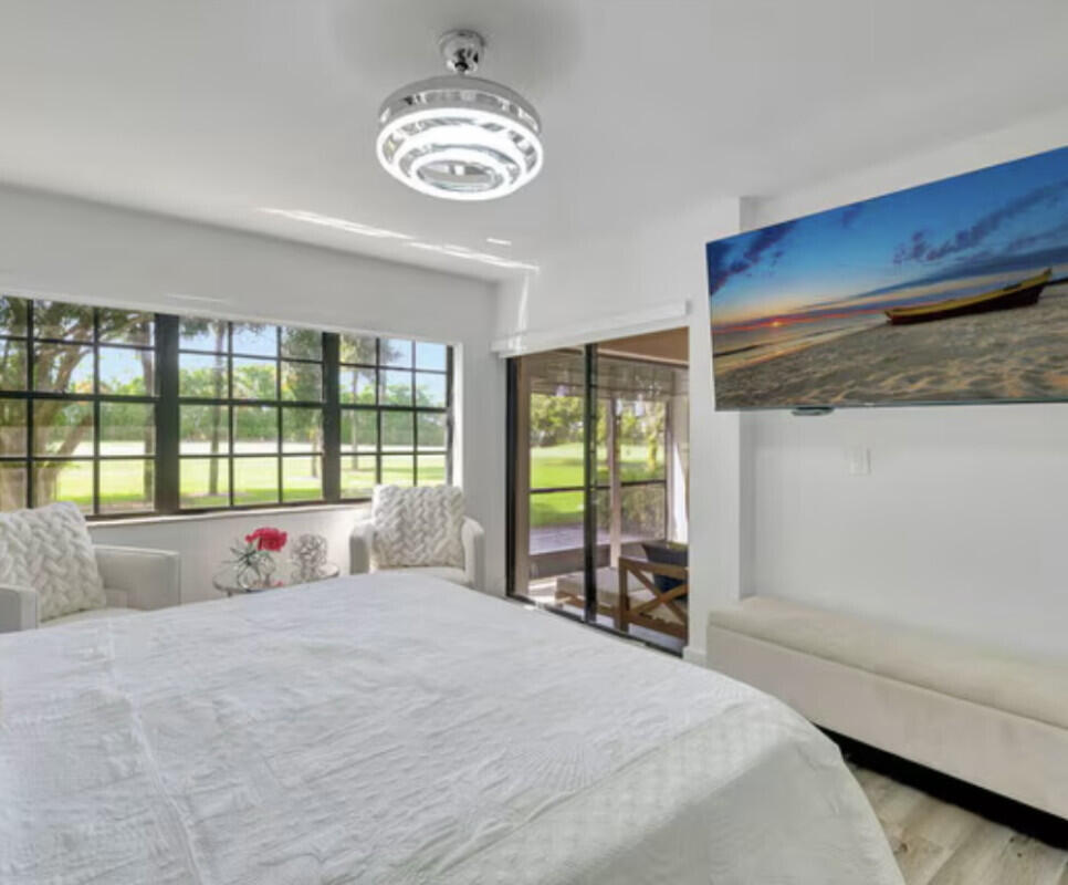 17372 Boca Club Boulevard, Unit 408 Boca Raton, FL 33487 - Photo 13 of 18 a bedroom with a large bed and a large window