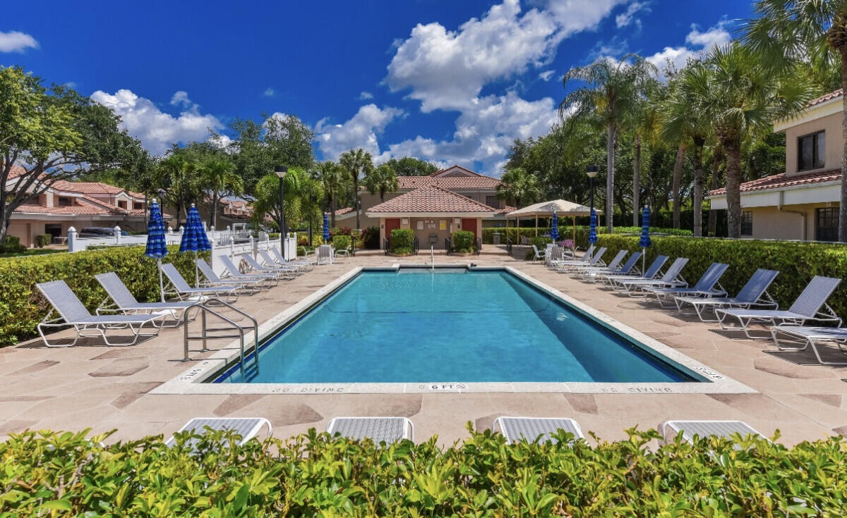 17372 Boca Club Boulevard, Unit 408 Boca Raton, FL 33487 - Photo 16 of 18 a view of swimming pool with outdoor seating and plants