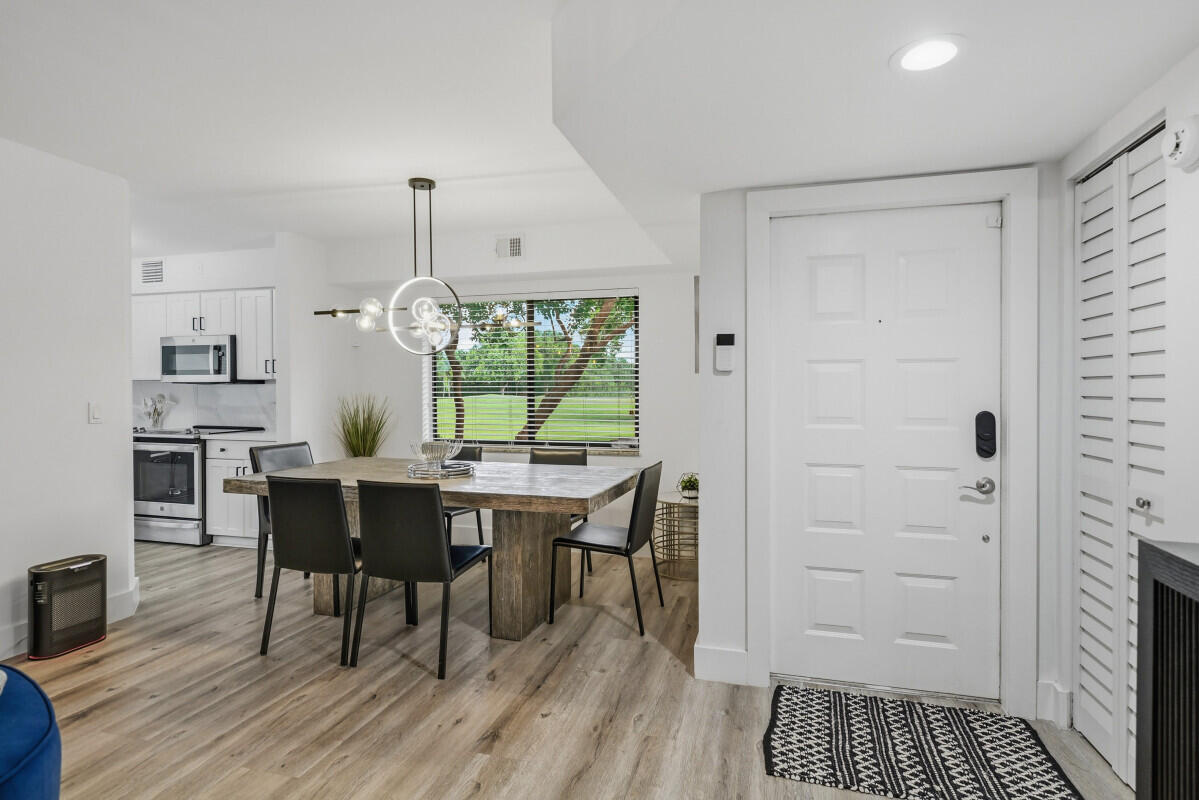 17372 Boca Club Boulevard, Unit 408 Boca Raton, FL 33487 - Photo 3 of 18 a kitchen with a table and chairs in it