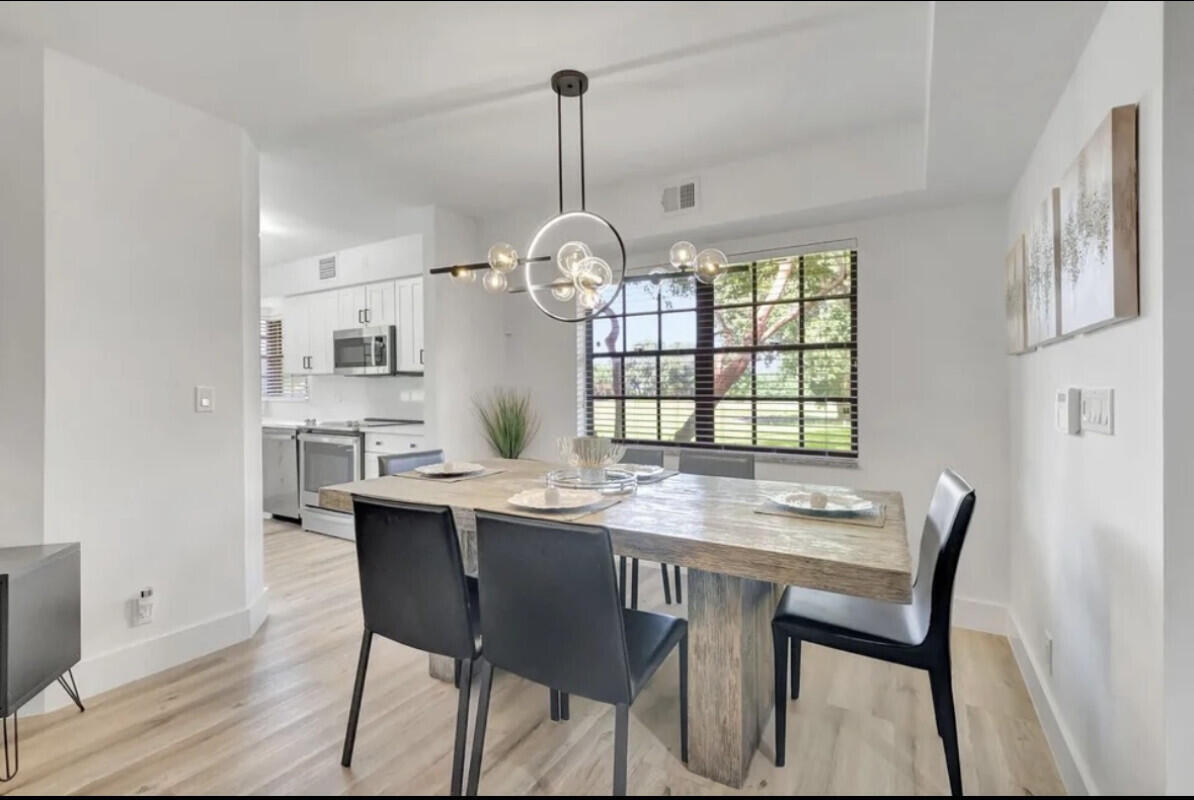 17372 Boca Club Boulevard, Unit 408 Boca Raton, FL 33487 - Photo 5 of 18 a view of a dining room with a table and chairs
