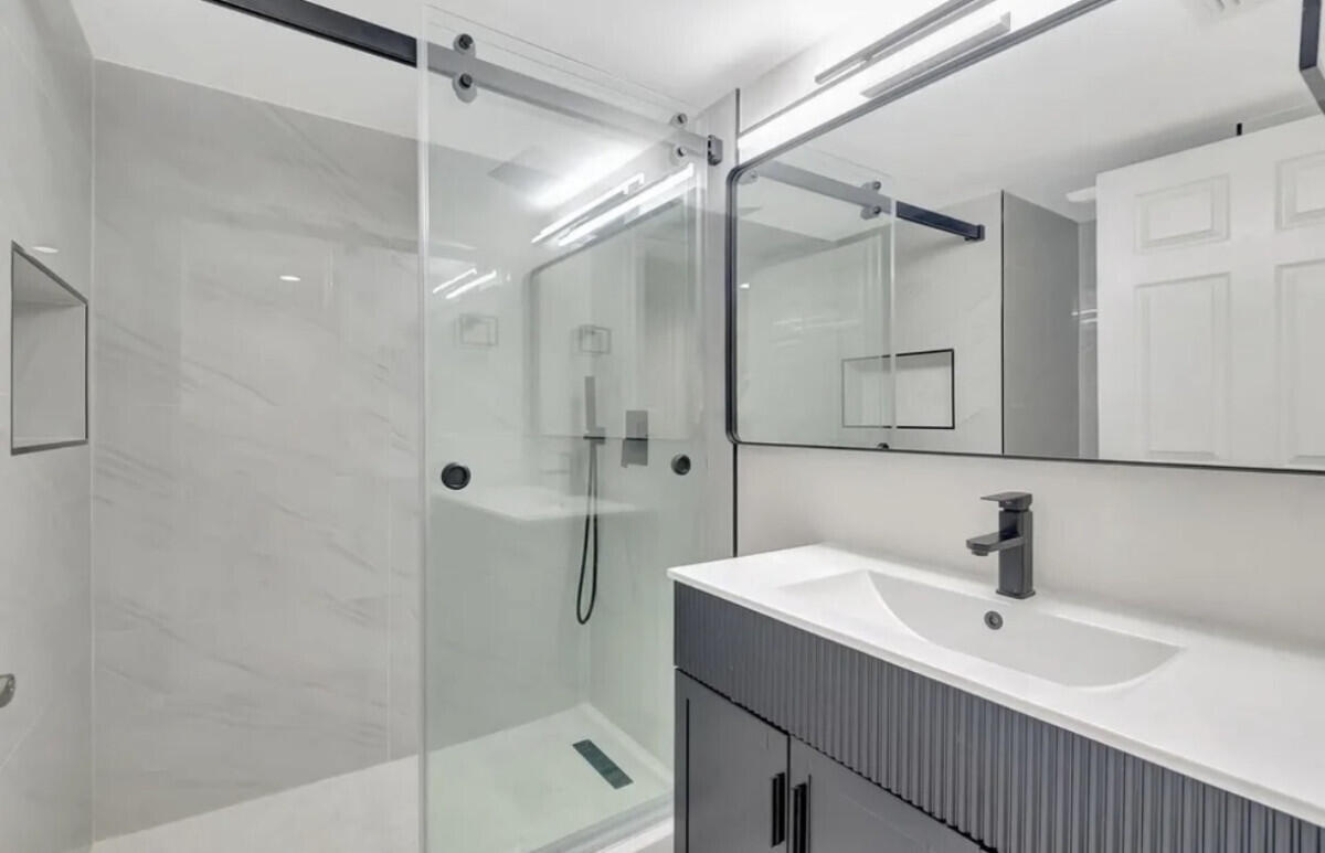 17372 Boca Club Boulevard, Unit 408 Boca Raton, FL 33487 - Photo 10 of 18 a bathroom with a sink shower and a mirror