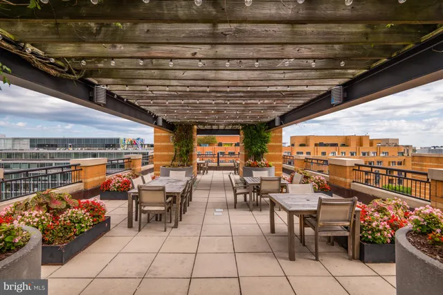 a view of a patio with dining table and chairs with plants