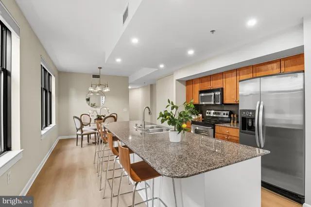 a kitchen with granite countertop lots of counter top space and stainless steel appliances