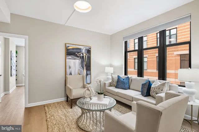 a living room with furniture and a large window