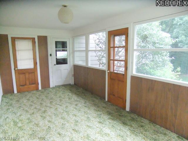 2141 Coon Road Akron, OH 44321 - Photo 6 of 16 The door to the left leads to the driveway, the white door leads to the attached 2 car garage and the door to the right leads to the patio.