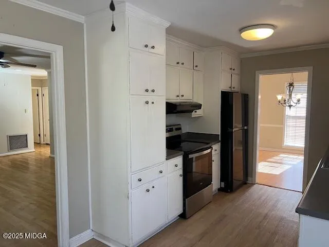 a kitchen with stainless steel appliances granite countertop a refrigerator and a stove
