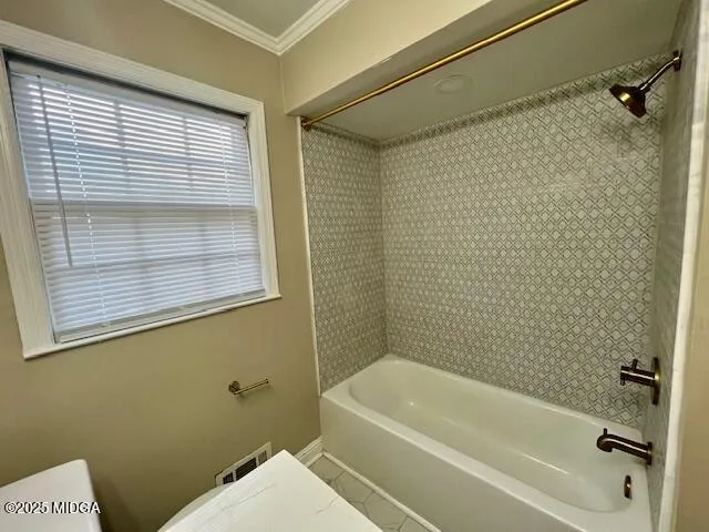 a bathroom with a toilet a bath tub and a shower