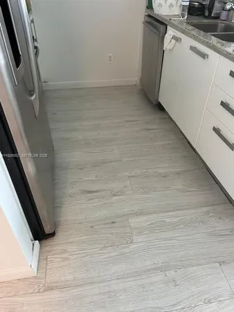 a view of a kitchen with wooden floor and staircase