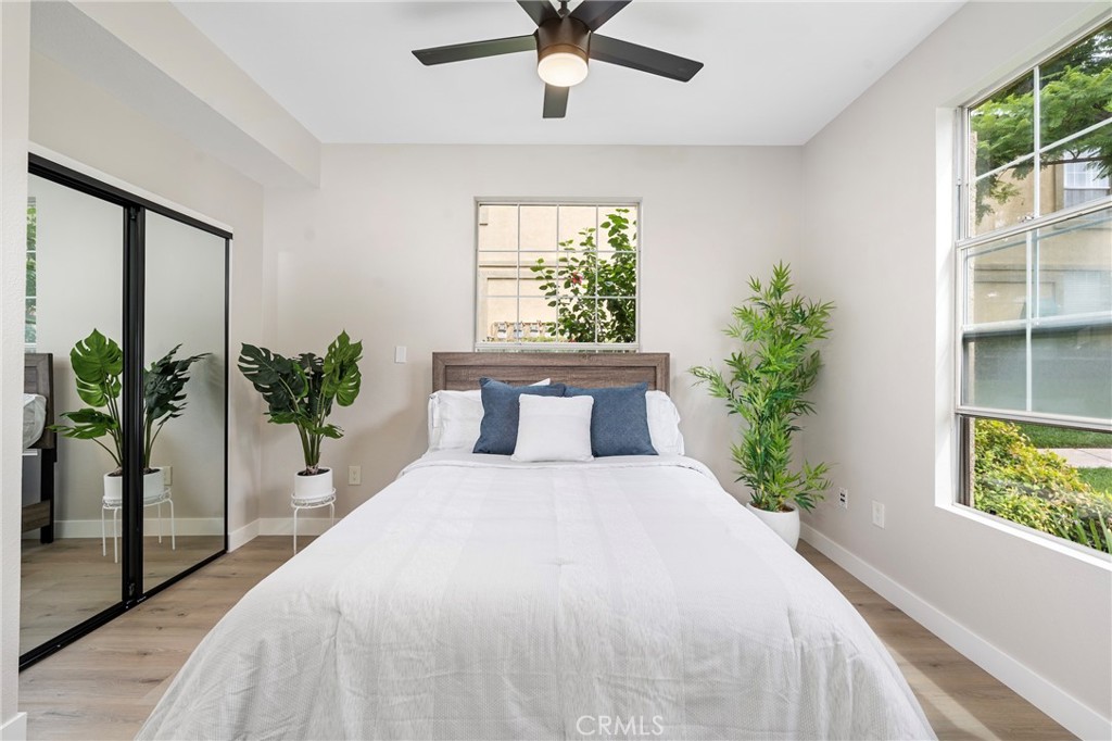 375 Central Avenue, Unit 151 Riverside, CA 92507 - Photo 22 of 52 a large bed sitting in a bedroom next to a window and a potted plant