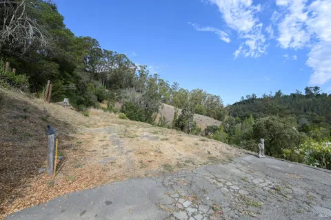 a view of a house with a mountain in the background