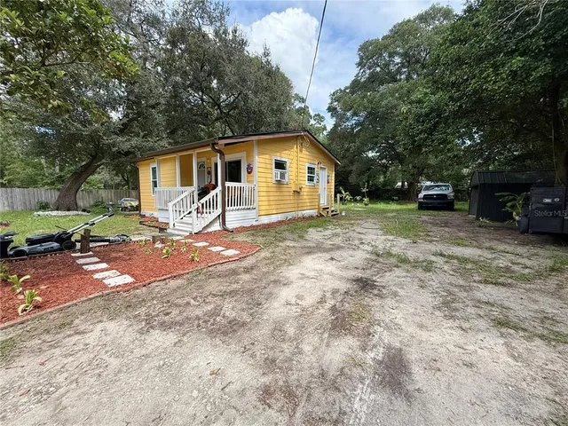 a view of a yard with a house and a tree