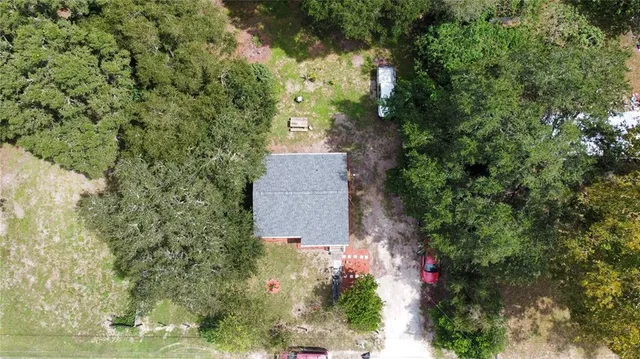 an aerial view of a house with a yard and garden