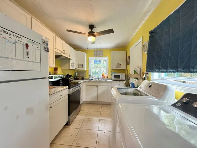 a kitchen with a sink appliances and cabinets
