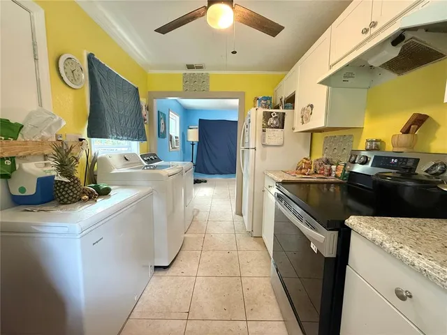 a kitchen with a sink appliances and cabinets