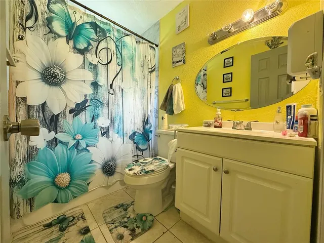 a bathroom with a sink mirror and vanity
