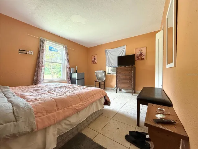 a bedroom with a bed and a window