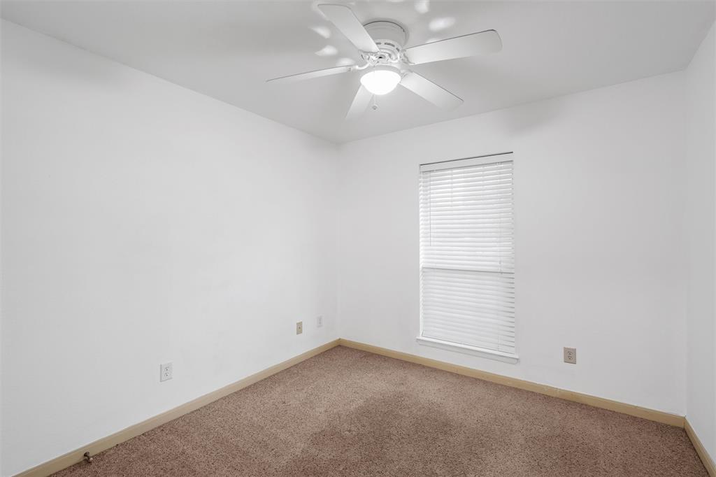 10121 Colony Drive Waco, TX 76708 - Photo 13 of 19 an empty room with a window and a ceiling fan