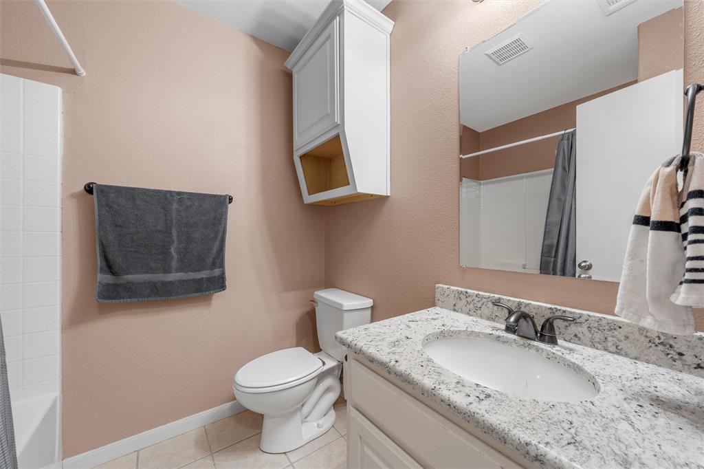 10121 Colony Drive Waco, TX 76708 - Photo 14 of 19 a bathroom with a granite countertop toilet sink and mirror