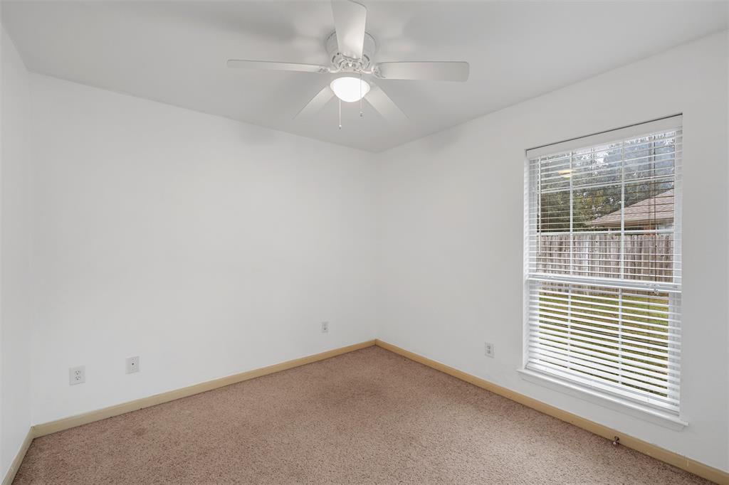 10121 Colony Drive Waco, TX 76708 - Photo 15 of 19 an empty room with a window and a ceiling fan