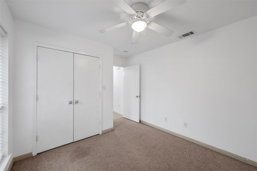 10121 Colony Drive Waco, TX 76708 - Photo 16 of 19 an empty room with a ceiling fan and a window