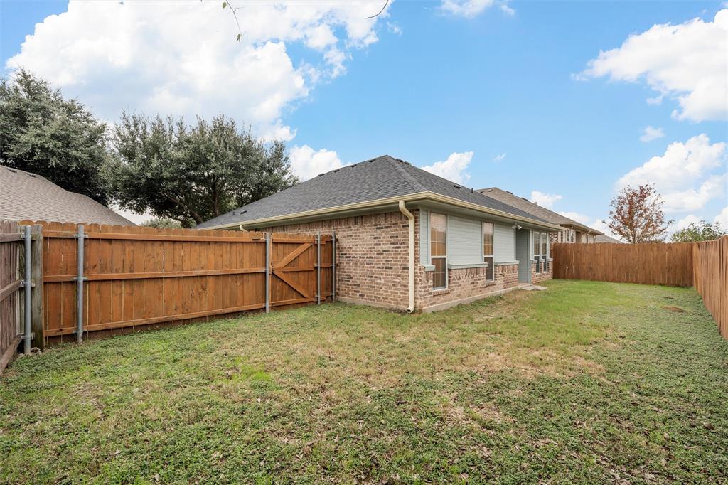 10121 Colony Drive Waco, TX 76708 - Photo 17 of 19 a white house that has a small yard and wooden fence