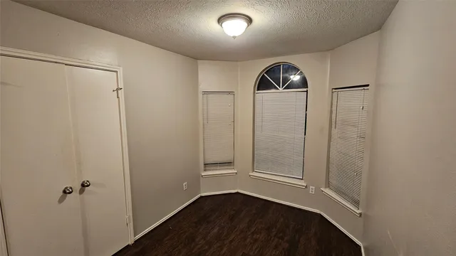 an empty room with wooden floor