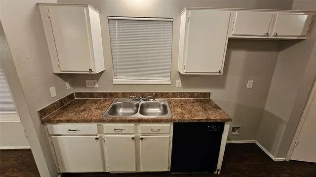 a kitchen with a sink and cabinets