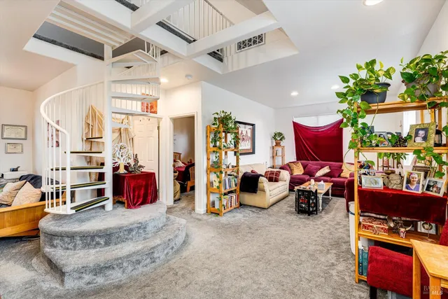 a living room with furniture and a floor to ceiling window