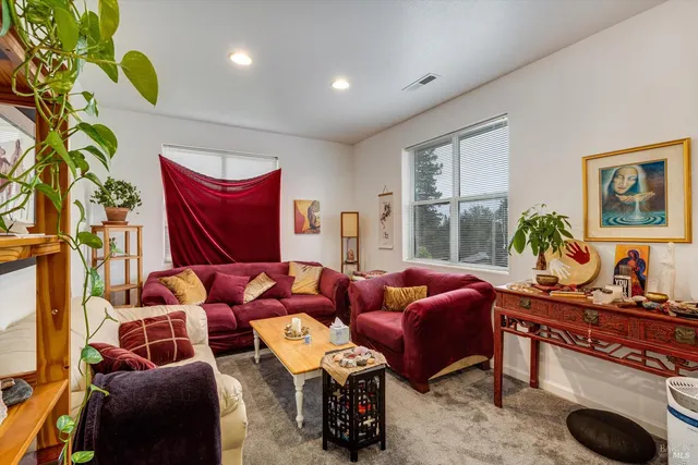 a living room with furniture a rug and a large window
