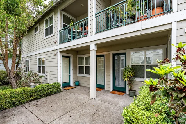 a house with potted plants in front of house