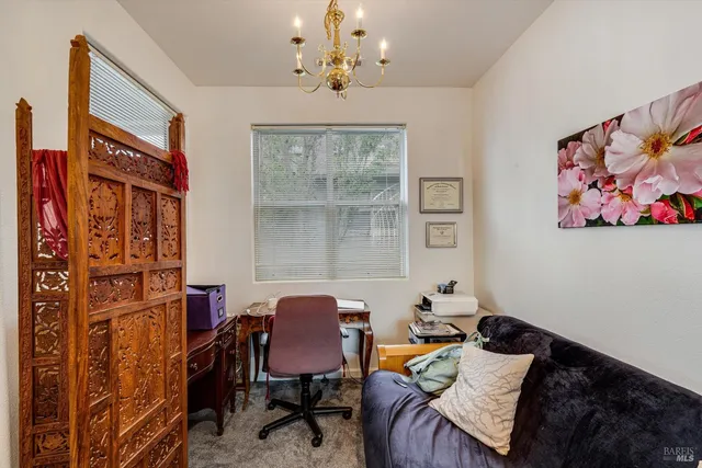 a bed room with a bed and a chair