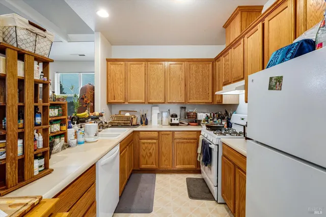 a kitchen with stainless steel appliances granite countertop a sink and cabinets