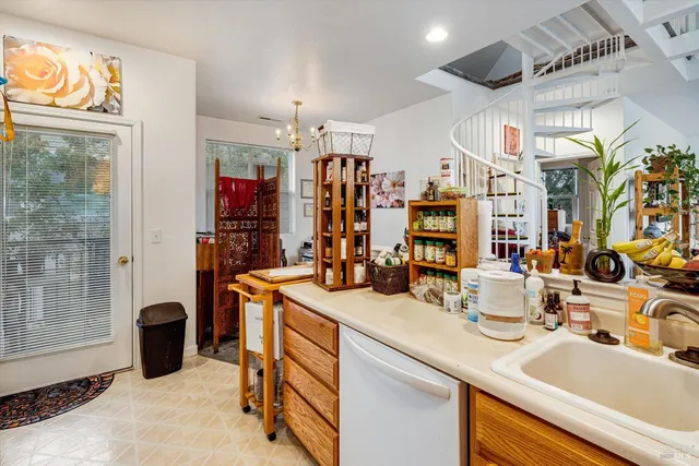 a kitchen with stainless steel appliances kitchen island granite countertop a sink and a refrigerator