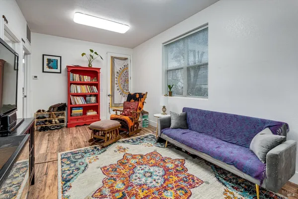 a living room with furniture and a book shelf